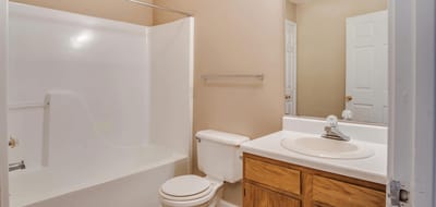 Clean bathroom with tub and mirror