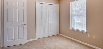 A well-lit interior room with closet doors