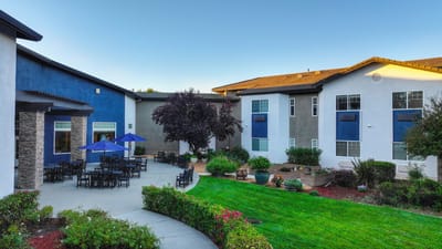 Outdoor courtyard with seating and umbrellas at Eskaton Granite Bay