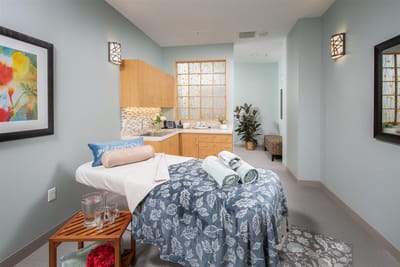 Spa treatment room with soothing decor and amenities