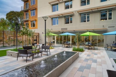 Outdoor patio area with colorful umbrellas and seating