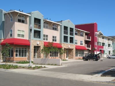 Exterior view of Johnson Gardens Apartments with colorful facades