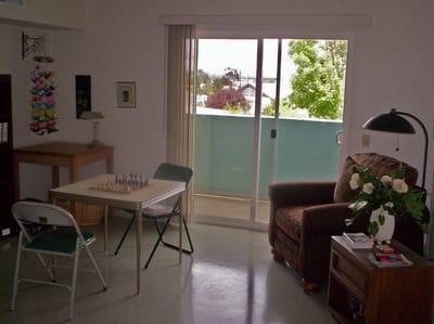 Cozy room with chess set and balcony view