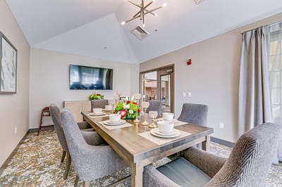 Elegant dining area with set table and flowers