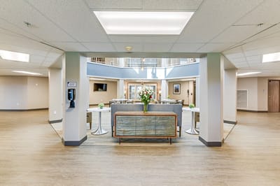 Bright common area with seating and floral arrangement