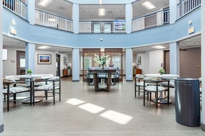A bright common area with tables and decor