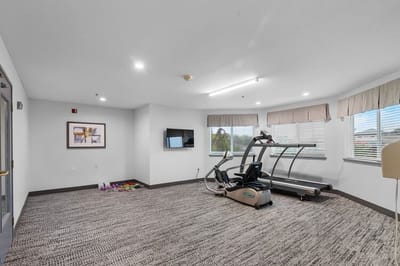 Fitness area with exercise equipment in a bright space