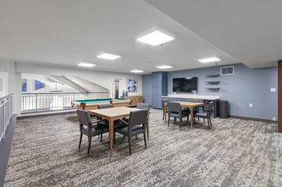 Bright interior common area with pool tables and seating