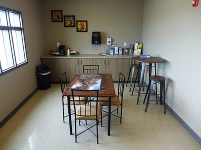 Bright common area with seating and a kitchenette
