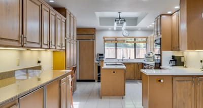Bright and spacious kitchen area with wooden cabinets