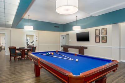 A billiards table in a recreational area with modern decor