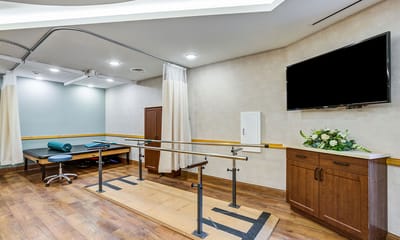Physical therapy space with equipment and a television