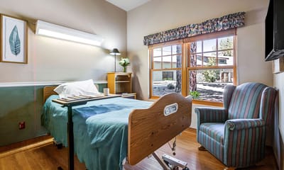 Cozy resident room with a bed and chair