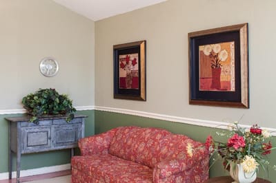 A cozy common area with floral decor and seating