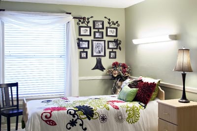 Cozy resident room with floral bedding and decorations