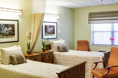 Bright interior view of a shared resident room with two beds