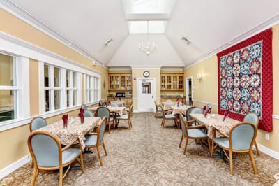 Bright dining room with tables set for a meal
