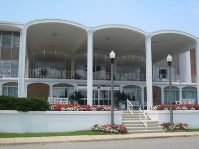 Exterior view of a senior living facility with gardens