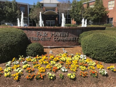 Exterior view of Fair Haven Retirement Community with flowers