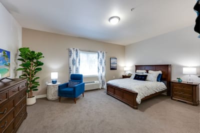 Bright and cozy resident room with a bed and furniture