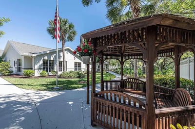 Outdoor gazebo with flowers and pathway leading to the facility
