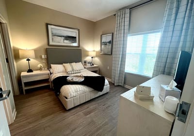 A cozy resident bedroom with natural light