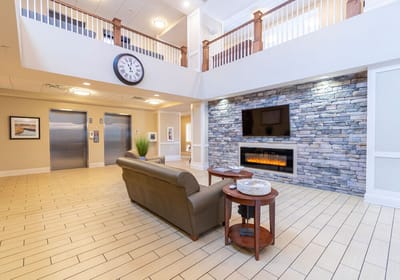 Common area with seating and decorative stone wall