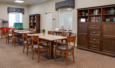 Bright common area with tables and bookshelves