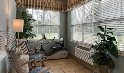 Exercise equipment in a sunlit corner of the facility