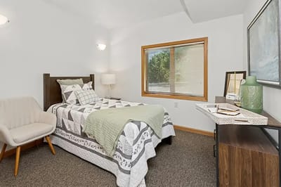 Brightly lit interior bedroom in a senior living facility