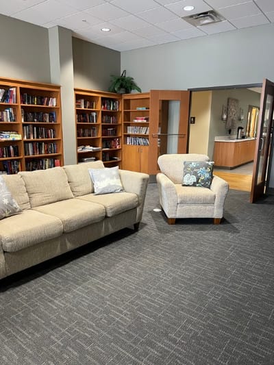 Cozy common area with seating and bookshelves