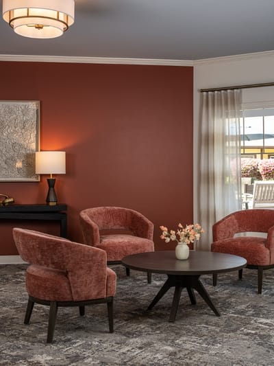 Cozy lounge area with pink chairs and a lamp