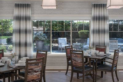 Dining area with tables, chairs, and outdoor views