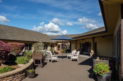 Outdoor patio area with seating and flowers