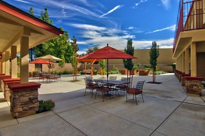 Outdoor courtyard with tables and umbrellas