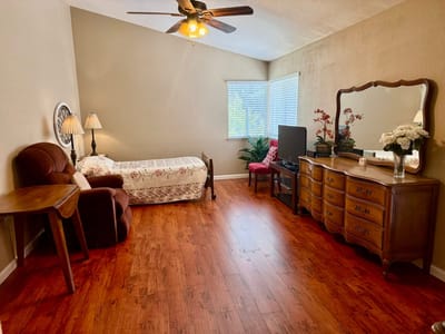 Well-furnished resident room with a bed and decorative lamp
