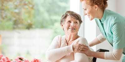 A caregiver interacting with a senior resident indoors