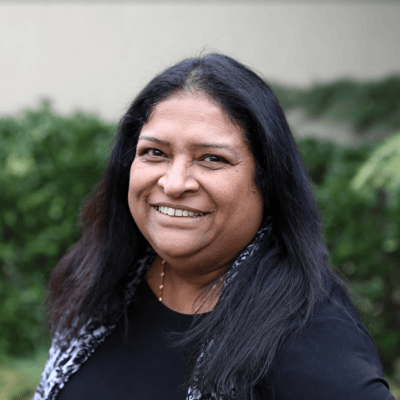 Smiling staff member outdoors at the facility