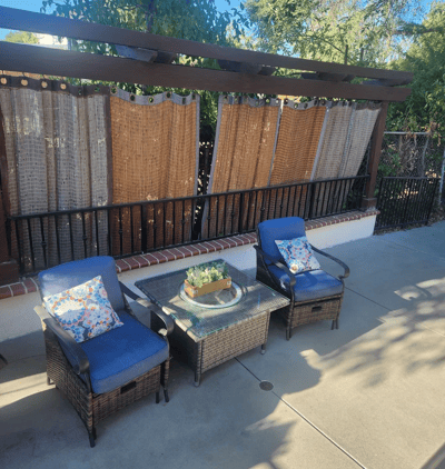 Outdoor seating area with two chairs and a table