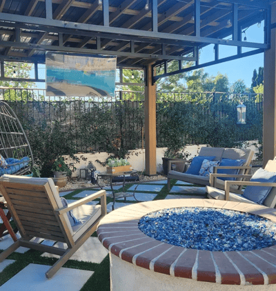 Outdoor seating area with fire pit and greenery