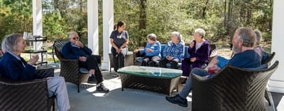 Residents socializing on a patio in pleasant weather