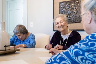 Residents engaged in a group activity at a table