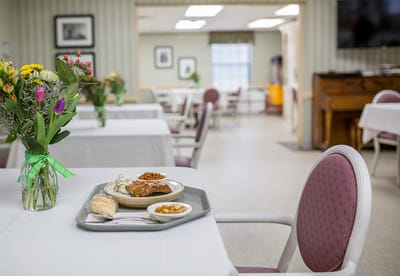 Dining area with meal service and floral arrangement