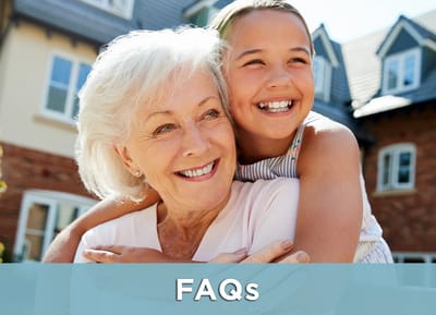 A woman and a girl smiling together outside