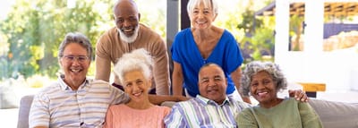 Residents smiling together in a sunny outdoor setting