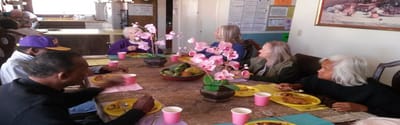 Residents enjoying a meal together at a dining table