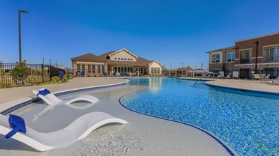 Outdoor pool area with lounge chairs