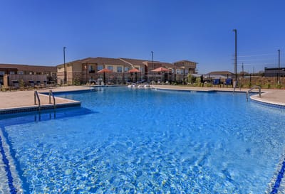 Outdoor pool area with seating and umbrellas