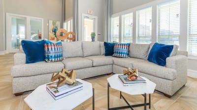 A cozy common area with a sectional sofa and decorative items