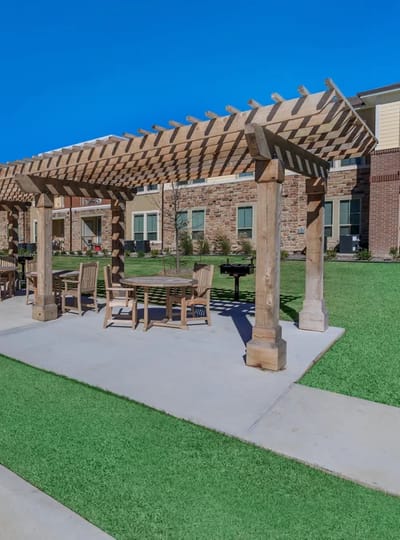 Outdoor seating area with a pergola in a senior living community